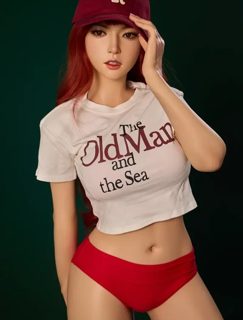 A mature full-silicone adult companion with red hair and casual styling